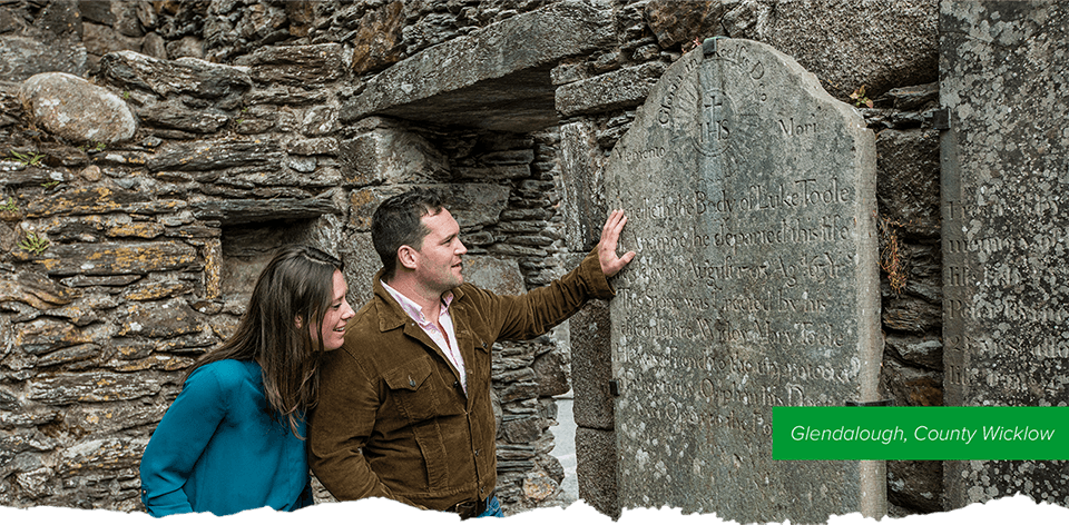 A couple looking an a stone tablet.