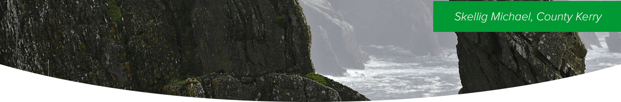 Skellig Michael, County Kerry - A woman standing on a cliff overlooking the ocean. 